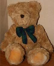 Teddy with navy tartan bow.